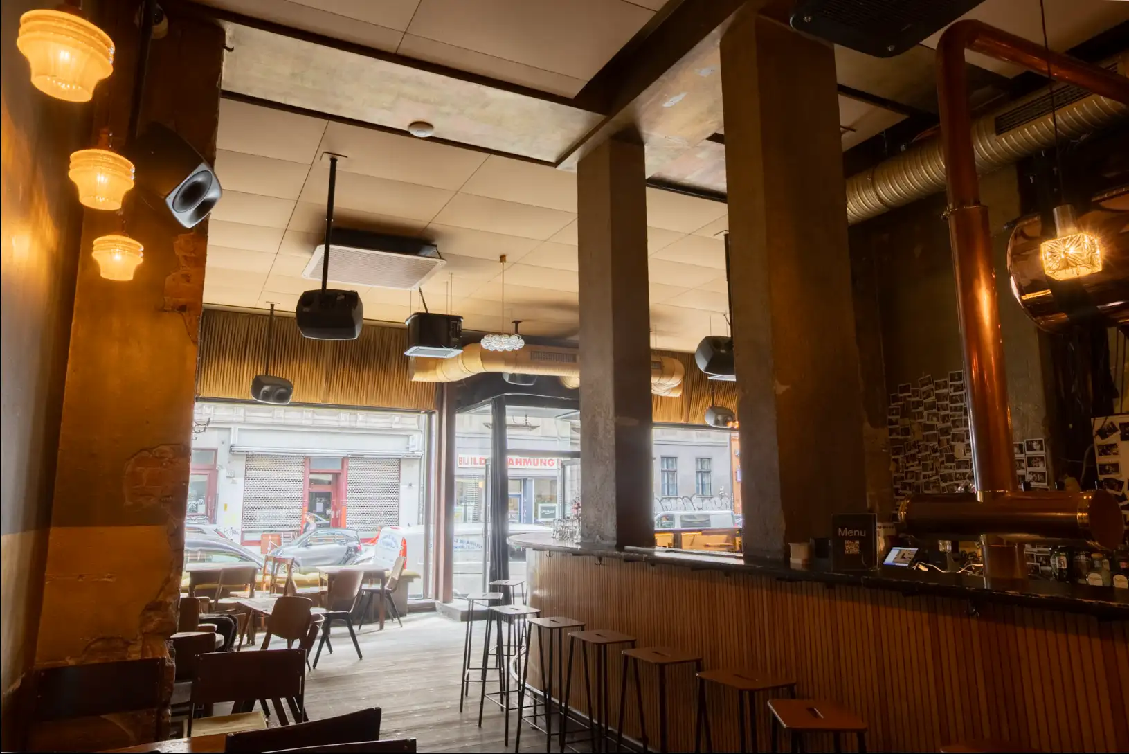 The golden acoustic ceiling and distributed speakers at Café Luzia